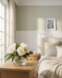 Cream peony bouquet in a Classic bowl on a Shaker-panelled bedside in a Hamptons-style Vaucluse home.