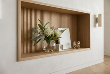 Pincushion sphere vase styled on a fluted French oak shelf in a South Yarra penthouse.