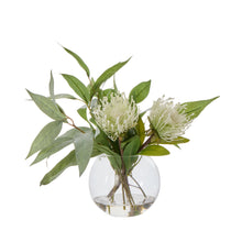 Cream pincushion flowers with eucalyptus leaves in round Sphere glass vase